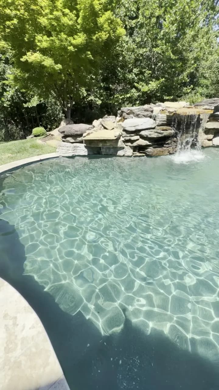 Pool with a stone waterfall and spa